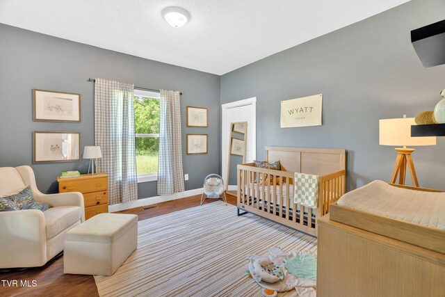 120 Stine St, Bristol, TN 37620 - bedroom with wood finished floors, baseboards, and a crib