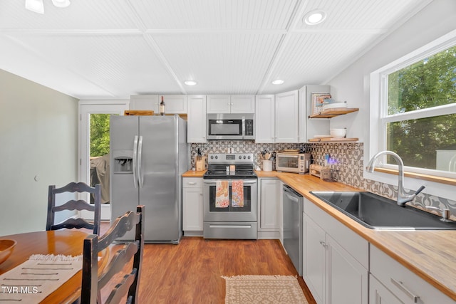 120 Stine St, Bristol, TN 37620 - kitchen with appliances with stainless steel finishes, butcher block counters, a sink, backsplash, and recessed lighting