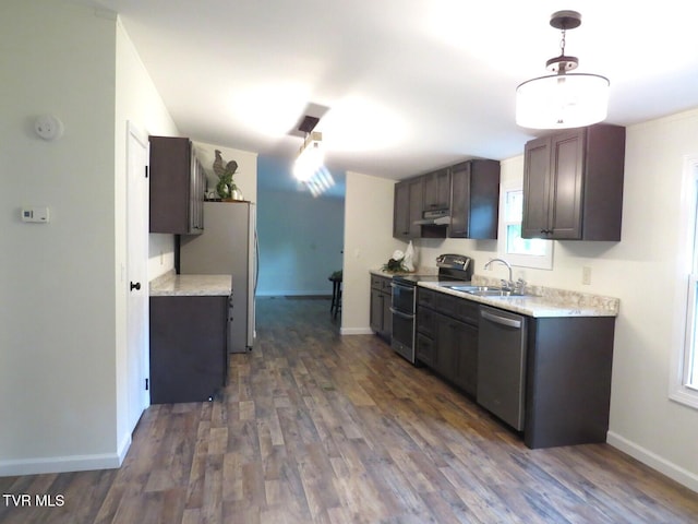 8929 Gateway Dr, Wise, VA 24293 - kitchen with appliances with stainless steel finishes, under cabinet range hood, light countertops, and dark wood finished floors