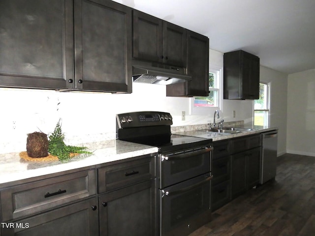 8929 Gateway Dr, Wise, VA 24293 - kitchen with double oven range, under cabinet range hood, dishwasher, a sink, and dark wood-style floors