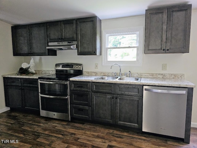 8929 Gateway Dr, Wise, VA 24293 - kitchen with stainless steel appliances, a sink, under cabinet range hood, dark wood-type flooring, and light countertops