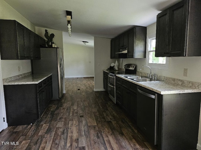 8929 Gateway Dr, Wise, VA 24293 - kitchen featuring appliances with stainless steel finishes, a sink, dark wood-style floors, under cabinet range hood, and light countertops