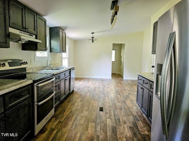 8929 Gateway Dr, Wise, VA 24293 - kitchen with stainless steel appliances, under cabinet range hood, a sink, dark wood finished floors, and baseboards