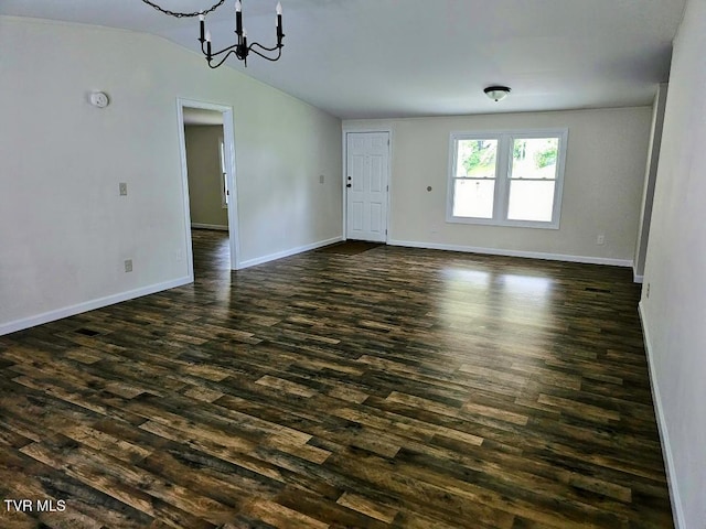 8929 Gateway Dr, Wise, VA 24293 - unfurnished living room featuring lofted ceiling, dark wood-style floors, a chandelier, and baseboards