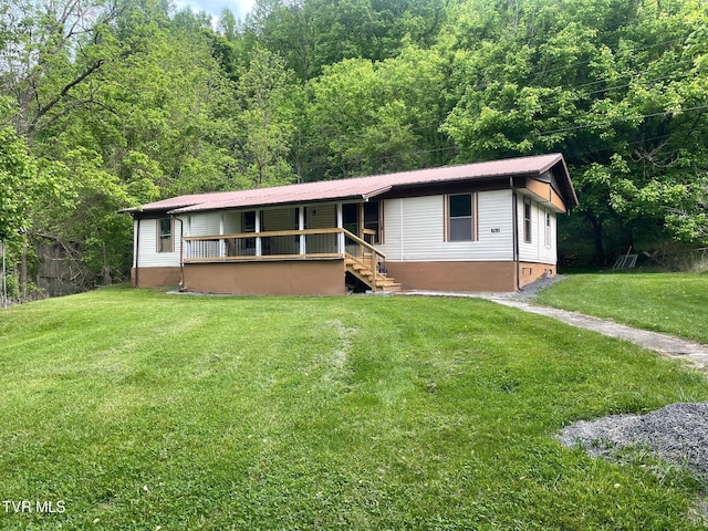 763 Sloantown Rd, Duffield, VA 24244 - ranch-style home featuring crawl space, a front lawn, metal roof, a forest view, and covered porch