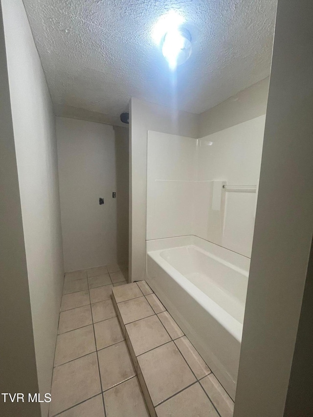 763 Sloantown Rd, Duffield, VA 24244 - bathroom featuring a textured ceiling, tile patterned flooring, and shower / bathtub combination