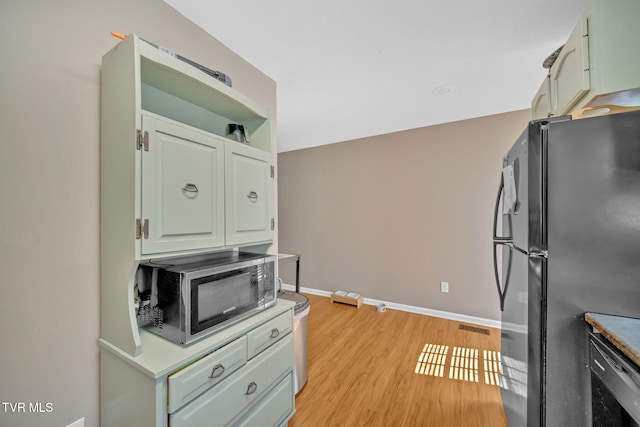 38 Lake Village Ct Unit 38, Johnson City, TN 37601 - kitchen featuring freestanding refrigerator, stainless steel microwave, light wood-style floors, and baseboards