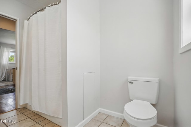 744 NE Hurricane Rd, Wise, VA 24293 - bathroom featuring tile patterned flooring, toilet, baseboards, and curtained shower