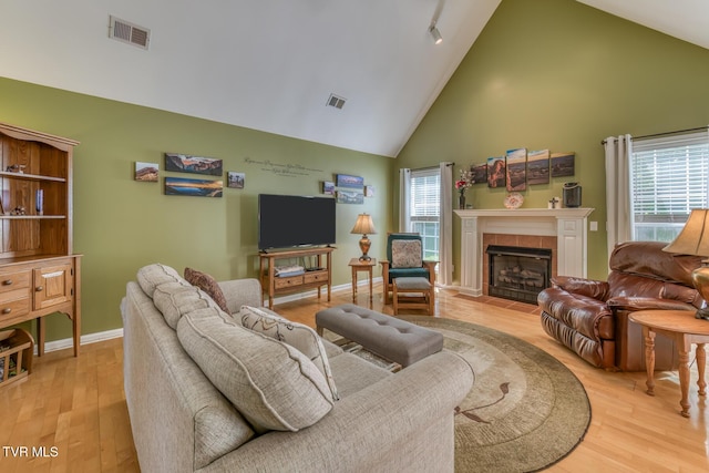 620 Glen Oaks Pl, Johnson City, TN 37615 - living room featuring high vaulted ceiling, wood finished floors, a fireplace, and baseboards