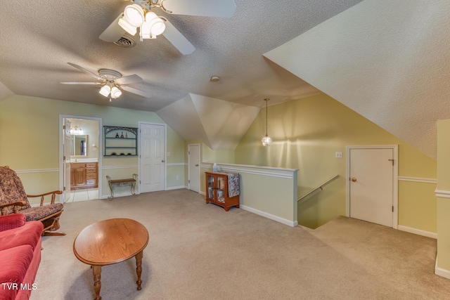620 Glen Oaks Pl, Johnson City, TN 37615 - sitting room featuring an upstairs landing, a ceiling fan, a textured ceiling, lofted ceiling, and carpet floors