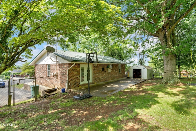 324 Reservoir St, Bristol, VA 24201 - rear view of property featuring french doors, brick siding, a patio area, a gate, and metal roof