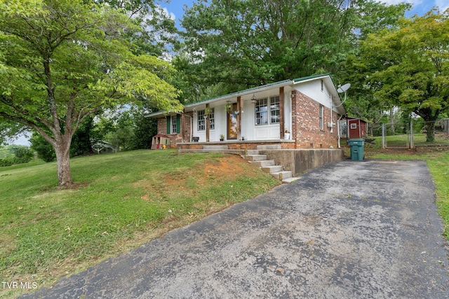 324 Reservoir St, Bristol, VA 24201 - ranch-style home with a porch, a front yard, brick siding, and asphalt driveway