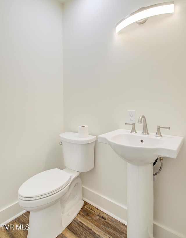 408 Levelin St, Erwin, TN 37650 - bathroom featuring toilet, baseboards, and wood finished floors