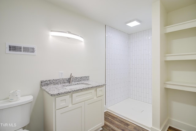 408 Levelin St, Erwin, TN 37650 - full bathroom featuring tiled shower, toilet, wood finished floors, vanity, and built in features