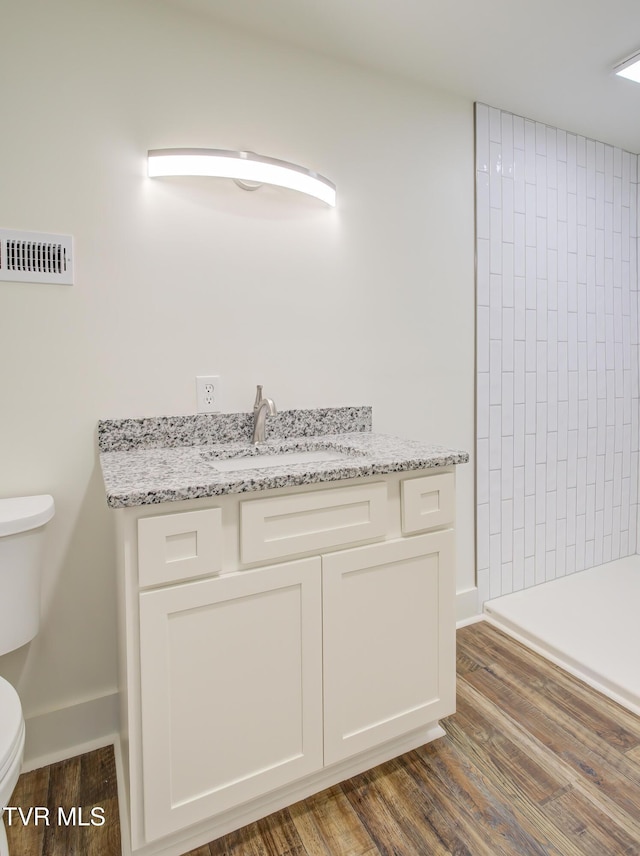 408 Levelin St, Erwin, TN 37650 - bathroom featuring toilet, vanity, and wood finished floors