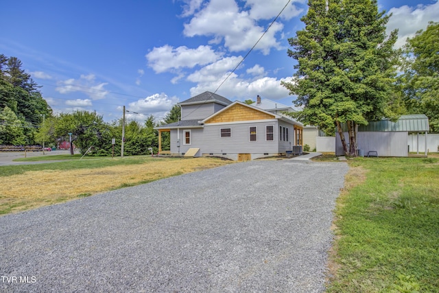408 Levelin St, Erwin, TN 37650 - view of front facade with a front yard, a shingled roof, and an outbuilding