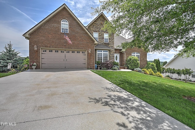 410 Grovemont Pl, Piney Flats, TN 37686 - traditional-style home with concrete driveway, a front yard, an attached garage, brick siding, and stone siding