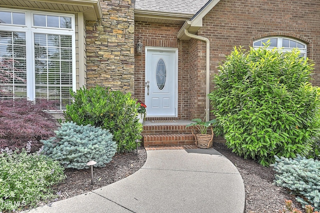 410 Grovemont Pl, Piney Flats, TN 37686 - doorway to property with a shingled roof, stone siding, and brick siding