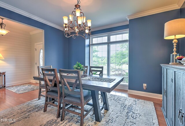 410 Grovemont Pl, Piney Flats, TN 37686 - dining space with wood finished floors, ornamental molding, baseboards, and a chandelier