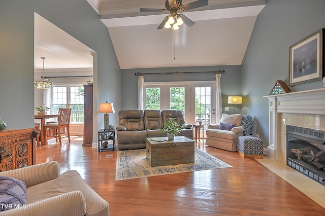410 Grovemont Pl, Piney Flats, TN 37686 - living room featuring a ceiling fan, a tiled fireplace, wood finished floors, a chandelier, and baseboards