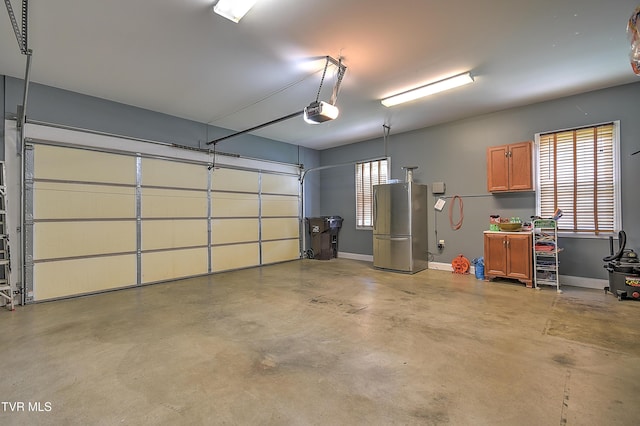 410 Grovemont Pl, Piney Flats, TN 37686 - garage featuring freestanding refrigerator, baseboards, and a garage door opener