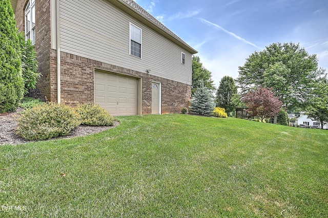 410 Grovemont Pl, Piney Flats, TN 37686 - view of home's exterior featuring brick siding, a garage, and a lawn