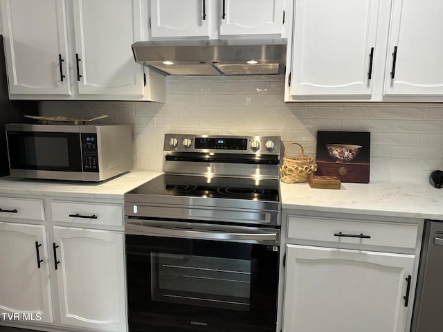 516 Fleetwood Ct Unit F, Kingsport, TN 37660 - kitchen featuring appliances with stainless steel finishes, extractor fan, white cabinets, and tasteful backsplash