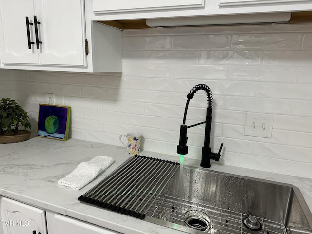 516 Fleetwood Ct Unit F, Kingsport, TN 37660 - kitchen view of a sink, white cabinets, tasteful backsplash, and light stone countertops