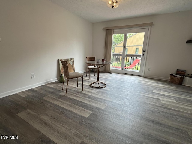 516 Fleetwood Ct Unit F, Kingsport, TN 37660 - dining space featuring wood finished floors, a textured ceiling, and baseboards