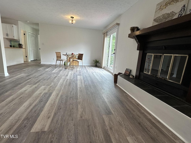 516 Fleetwood Ct Unit F, Kingsport, TN 37660 - dining room featuring wood finished floors, a textured ceiling, and baseboards