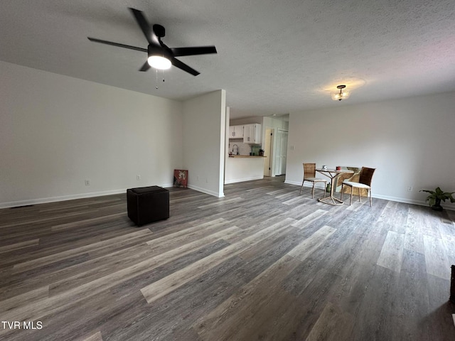 516 Fleetwood Ct Unit F, Kingsport, TN 37660 - living room featuring dark wood-type flooring, a textured ceiling, baseboards, and a ceiling fan