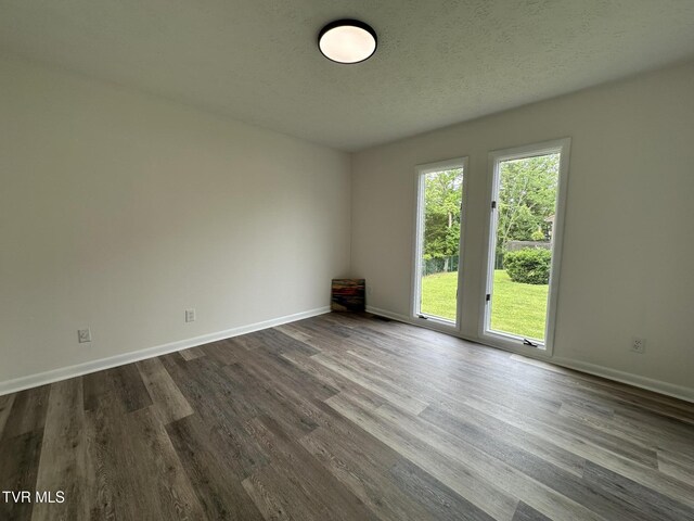 516 Fleetwood Ct Unit F, Kingsport, TN 37660 - spare room with dark wood-style flooring, baseboards, and a textured ceiling