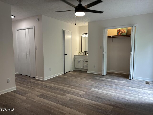 516 Fleetwood Ct Unit F, Kingsport, TN 37660 - unfurnished bedroom featuring wood finished floors, baseboards, a sink, and ensuite bath