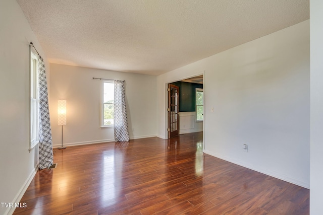 219 Meridale Dr, Johnson City, TN 37601 - spare room with healthy amount of natural light, a textured ceiling, wood finished floors, and baseboards