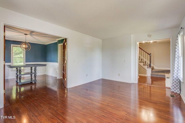 219 Meridale Dr, Johnson City, TN 37601 - empty room featuring a chandelier, stairs, wainscoting, and wood finished floors