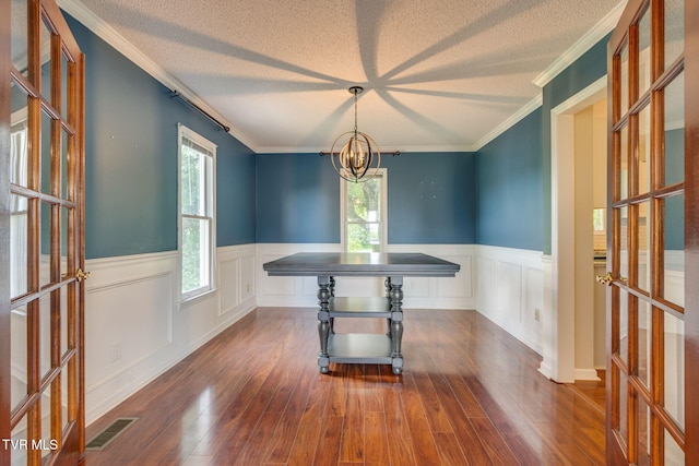 219 Meridale Dr, Johnson City, TN 37601 - unfurnished dining area featuring healthy amount of natural light, wainscoting, wood finished floors, french doors, and a textured ceiling