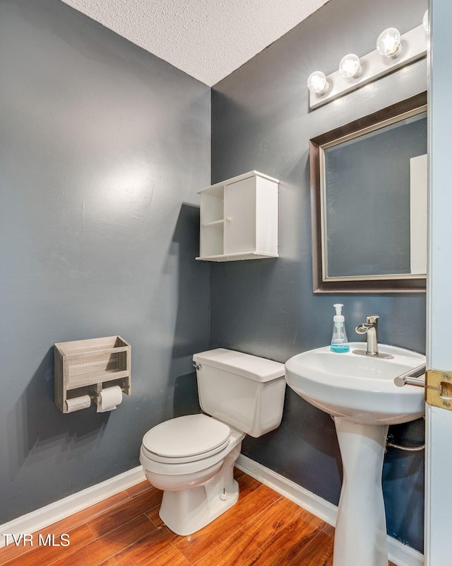 219 Meridale Dr, Johnson City, TN 37601 - bathroom featuring wood finished floors, toilet, baseboards, and a textured ceiling