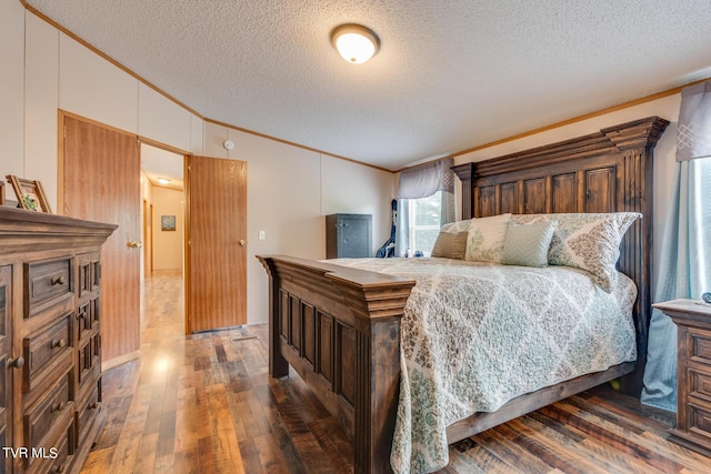 6855 Gate City Hwy, Bristol, VA 24202 - bedroom with ornamental molding, vaulted ceiling, a textured ceiling, and wood finished floors