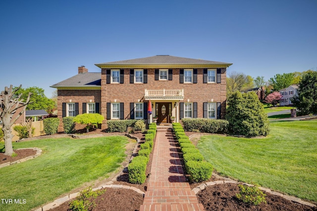 2001 Springfield Ave, Kingsport, TN 37664 - colonial-style house featuring a front lawn, brick siding, and a chimney