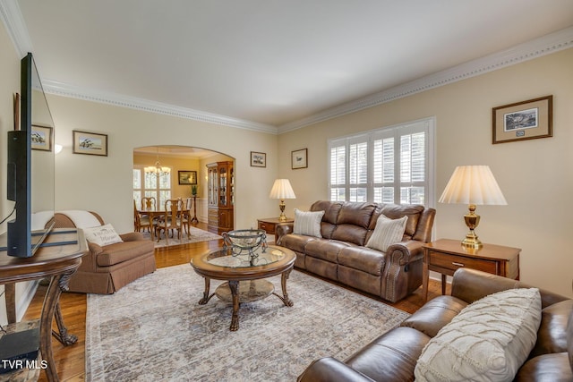 2001 Springfield Ave, Kingsport, TN 37664 - living room with arched walkways, wood finished floors, ornamental molding, plenty of natural light, and a chandelier