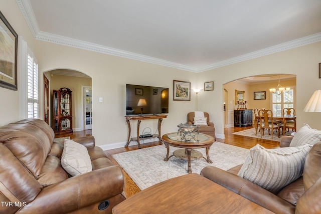 2001 Springfield Ave, Kingsport, TN 37664 - living area featuring arched walkways, ornamental molding, wood finished floors, baseboards, and a chandelier