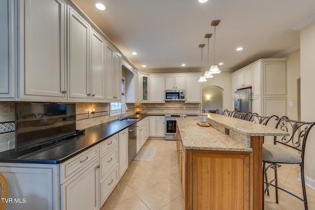 2001 Springfield Ave, Kingsport, TN 37664 - kitchen with stainless steel appliances, a sink, a breakfast bar area, light tile patterned flooring, and crown molding