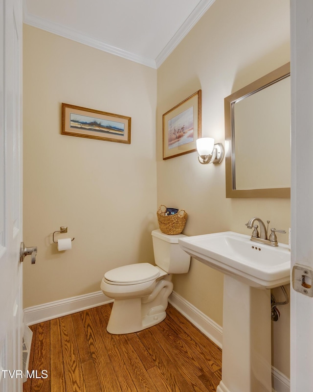 2001 Springfield Ave, Kingsport, TN 37664 - half bathroom with toilet, crown molding, wood finished floors, baseboards, and a sink