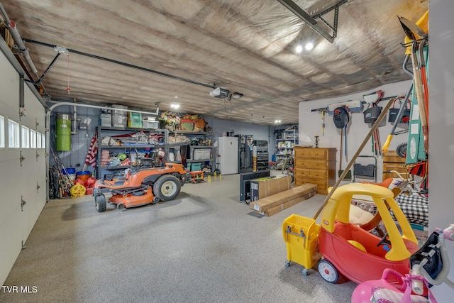 2001 Springfield Ave, Kingsport, TN 37664 - garage with a central vacuum unit, a garage door opener, and freestanding refrigerator