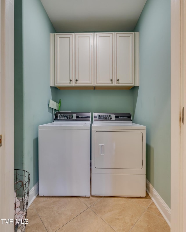 2001 Springfield Ave, Kingsport, TN 37664 - laundry room featuring cabinet space, independent washer and dryer, light tile patterned floors, and baseboards