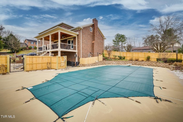 2001 Springfield Ave, Kingsport, TN 37664 - view of swimming pool featuring ceiling fan, a fenced backyard, a gate, stairway, and a diving board