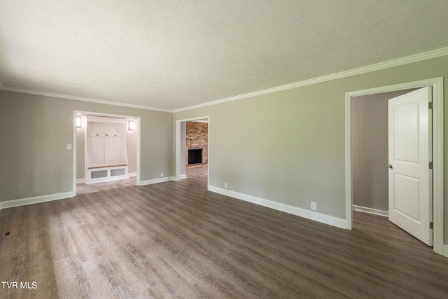 1236 Nassau Dr, Kingsport, TN 37660 - unfurnished living room featuring dark wood-style flooring, baseboards, a fireplace, crown molding, and a textured ceiling