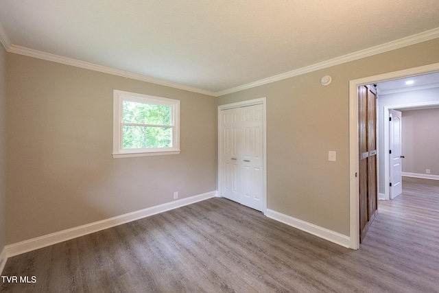 1236 Nassau Dr, Kingsport, TN 37660 - unfurnished bedroom featuring wood finished floors, crown molding, baseboards, and a closet