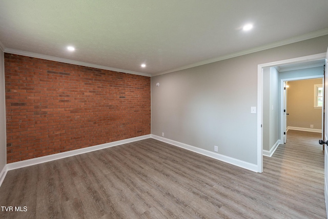 1236 Nassau Dr, Kingsport, TN 37660 - unfurnished room featuring brick wall, wood finished floors, baseboards, recessed lighting, and ornamental molding