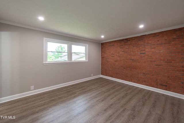1236 Nassau Dr, Kingsport, TN 37660 - empty room with brick wall, dark wood finished floors, crown molding, baseboards, and recessed lighting